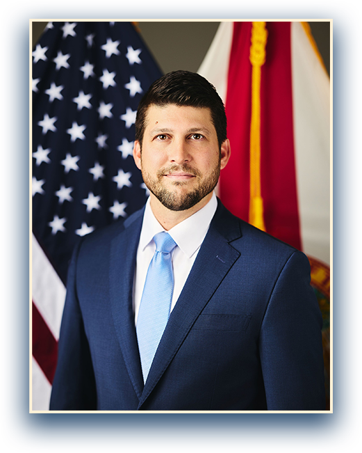 Florida Attorney General standing in front of the state seal